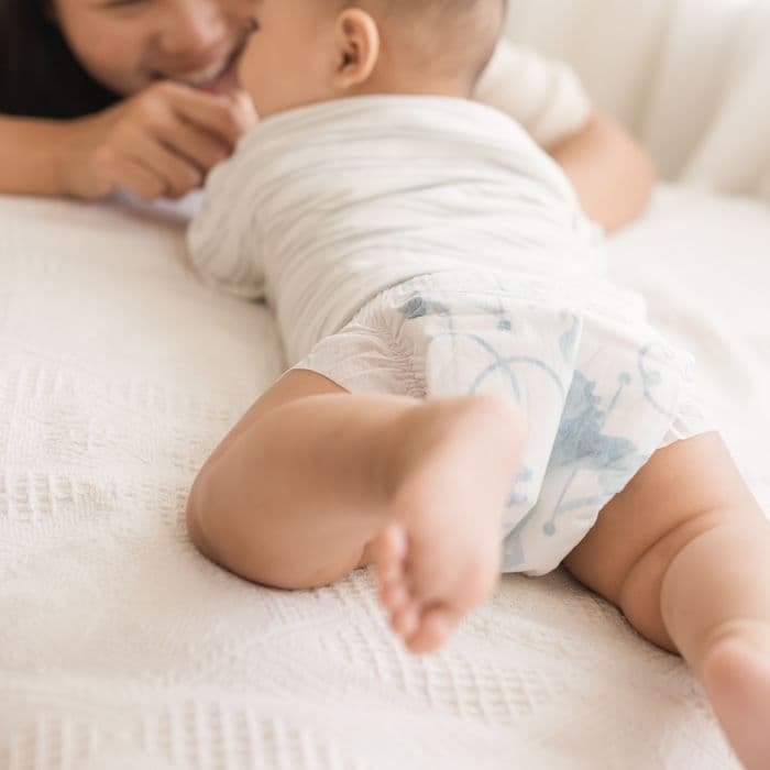 A baby crawling to their mum in a Little Rei tape diaper