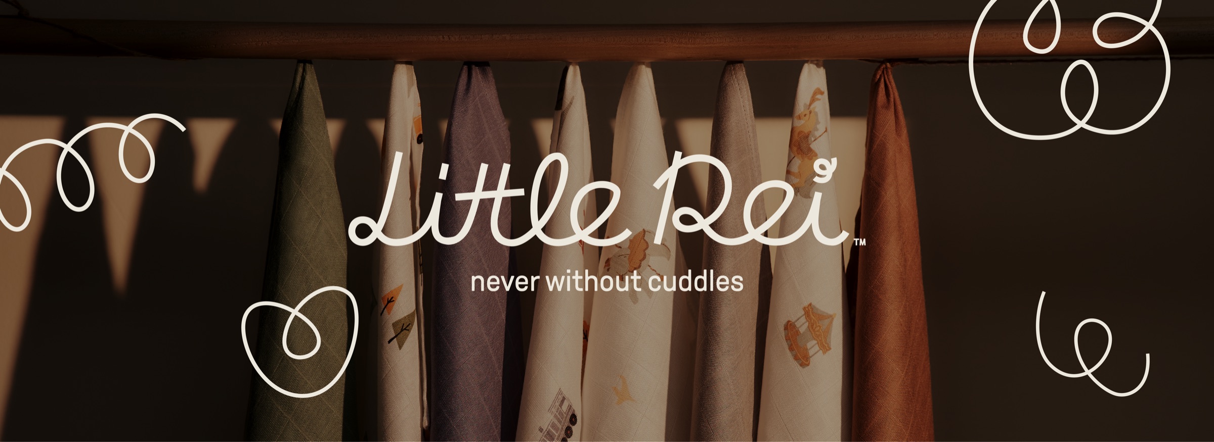 Little Rei, never without cuddles. Bamboo swaddles hanging in evening light.